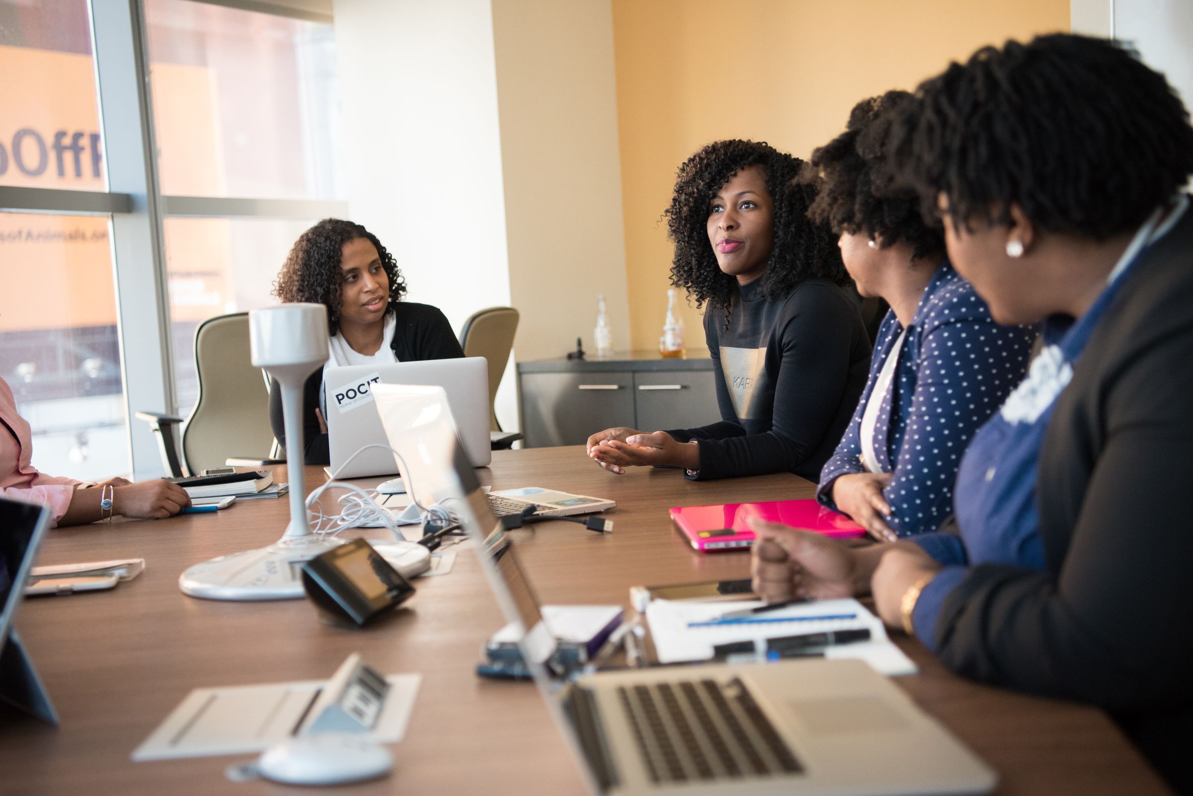 Black woman executive leading a strategic business discussion with colleagues in a boardroom